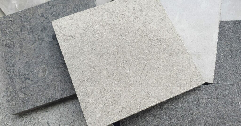 A pile of grey and white marble slabs.